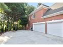Spacious three-car garage with an adjacent driveway offering ample parking and outdoor activity space at 3741 Cape York Trce, Alpharetta, GA 30022