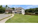 Charming two-story home with well-maintained lawn and landscaping, plus a long driveway to the attached garage at 610 Brickstone Ct, Covington, GA 30016