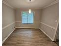 Neutral dining room with modern floors, chair rail, and updated light fixture at 636 Raven Springs Trl, Stone Mountain, GA 30087