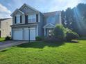 Traditional two-story home with a well-maintained lawn and an attached two-car garage at 2527 Plymouth Way, Conyers, GA 30013