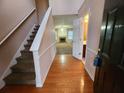 Inviting foyer featuring hardwood floors, a staircase, and views into the adjacent living room at 2527 Plymouth Way, Conyers, GA 30013