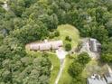 Aerial view of home with a long, winding driveway and plenty of lush greenery at 2760 Hembree Ne Rd, Marietta, GA 30062