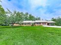 Charming one story home featuring a large front lawn, attached carport, and covered porch at 2760 Hembree Ne Rd, Marietta, GA 30062