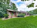 Beautiful ranch style home with a lush green lawn and manicured shrubs at 2760 Hembree Ne Rd, Marietta, GA 30062