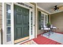 Elegant front door with sidelights, leading to a cozy front porch sitting area at 28 Mcevers Branch Ct, Acworth, GA 30101