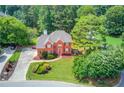 Beautiful home with landscaped yard, long driveway, and lush green trees surrounding the property at 3082 Biltmore Woods Dr, Buford, GA 30519