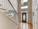 Grand foyer with a staircase, hardwood floors, and a statement chandelier creates a welcoming entrance at 3082 Biltmore Woods Dr, Buford, GA 30519