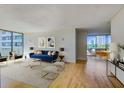Comfortable living room with a blue couch and a view at 2575 Peachtree Ne Rd # 15G, Atlanta, GA 30305