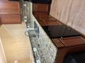 Modern kitchen with granite countertops, stainless steel sink, and dark wood cabinets at 1629 Marsanne Ter, Kennesaw, GA 30152