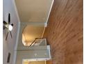 Bright living room with hardwood floors, fan, and an archway leading to the staircase at 1629 Marsanne Ter, Kennesaw, GA 30152