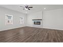 Well-lit living room featuring hardwood floors, modern windows, and a fireplace creating a welcoming space at 3382 Monarch Ave, Duluth, GA 30096