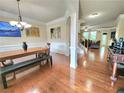Bright dining room with hardwood floors, decorative trim, and an open layout at 827 Autry Oak Ct, Johns Creek, GA 30022