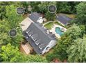 Aerial view of the property featuring a main house, guest house, and detached garage at 1824 Mount Paran Nw Rd, Atlanta, GA 30327