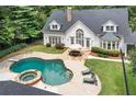 Backyard view showcasing a pristine pool, hot tub, and outdoor dining area at 1824 Mount Paran Nw Rd, Atlanta, GA 30327