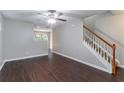 View of the living room with hardwood floors and a staircase with wood trim at 3458 Carriage Chase Rd, Atlanta, GA 30349