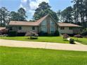 Inviting single-story home showcasing well-maintained landscaping and a stone accent wall at 115 Cannongate Cir, Sharpsburg, GA 30277
