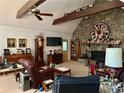 Large living room featuring stone fireplace, a beamed ceiling, and lots of decorations at 115 Cannongate Cir, Sharpsburg, GA 30277