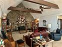 Spacious living room with a unique stone fireplace, vaulted ceiling, and comfortable seating at 115 Cannongate Cir, Sharpsburg, GA 30277