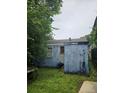 View of the back of the house from the overgrown backyard at 133 Buchanan Ln, Atlanta, GA 30315