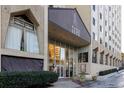 Building entrance with modern glass facade, signage and landscaped entryway with planters at 2479 Peachtree Ne Rd # 1714, Atlanta, GA 30305
