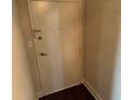A simple white door with a dark handle and peephole stands between neutral colored walls at 2479 Peachtree Ne Rd # 1714, Atlanta, GA 30305