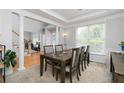 Elegant dining room featuring tray ceilings and lots of light from the large windows at 2693 Blairsden Nw Pl, Kennesaw, GA 30144