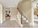 Welcoming foyer featuring tile flooring and a staircase with a wooden banister at 4313 Deep Springs Nw Ct, Kennesaw, GA 30144