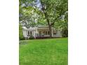 Charming bungalow with a welcoming front porch, light gray siding, and well-manicured lawn in a serene setting at 55 Cooper Lake Rd, Mableton, GA 30126