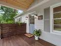 Inviting front entrance featuring a stylish blue door, classic lighting, and a 'Welcome' mat on a wooden deck at 55 Cooper Lake Rd, Mableton, GA 30126