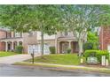 Well-maintained brick home with a two-car garage, lush lawn, and mature trees in a suburban setting at 909 Pine Cove Dr, Lilburn, GA 30047