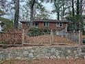 Charming brick home featuring mature trees and a stone retaining wall at 1917 Penelope Nw Rd, Atlanta, GA 30314