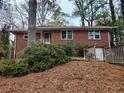 Red brick home featuring mature trees and landscaping at 1917 Penelope Nw Rd, Atlanta, GA 30314