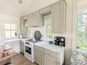 Bright kitchen featuring stainless appliances, stone counters, and natural light at 10540 Serenbe Ln, Chattahoochee Hills, GA 30268