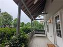 Inviting porch with swing, ceiling fan, and views of landscaped surroundings at 10540 Serenbe Ln, Chattahoochee Hills, GA 30268