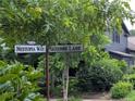 Street view showcasing the street sign for Nestopia Way and Serenbe Lane at 10540 Serenbe Ln, Chattahoochee Hills, GA 30268