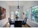 Elegant dining room featuring a marble table, chandelier, and natural lighting at 115 Dahlia Nw Ave, Atlanta, GA 30314