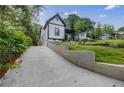 Long driveway leading up to a charming home with new concrete retaining wall at 115 Dahlia Nw Ave, Atlanta, GA 30314