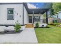 Inviting front porch with black railings and a ceiling fan, enhancing the home's appeal at 115 Dahlia Nw Ave, Atlanta, GA 30314
