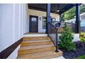 Inviting front porch with stairs and black railings, perfect for relaxing outdoors at 115 Dahlia Nw Ave, Atlanta, GA 30314