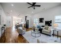 Open-concept living room and kitchen with hardwood floors and modern lighting at 115 Dahlia Nw Ave, Atlanta, GA 30314