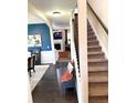 Inviting entryway featuring a staircase, dark wood floors, and stylish decor, creating a warm welcome at 124 Gorham Gates Ct, Hiram, GA 30141