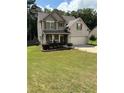 Charming two-story home with a manicured lawn, brick accents, and a welcoming front porch at 124 Gorham Gates Ct, Hiram, GA 30141