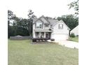 Beautiful two-story house featuring a lush lawn, and an attached two-car garage, perfect for suburban living at 124 Gorham Gates Ct, Hiram, GA 30141