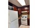 Bright kitchen featuring white appliances, ample cabinets, and tiled floors at 1807 Ashborough Se Cir # B, Marietta, GA 30067