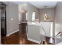 Elegant foyer boasts hardwood floors, a modern chandelier, and an arched entryway, creating a grand and inviting space at 5414 Sweetsprings Sw Dr, Powder Springs, GA 30127