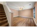 Spacious living room featuring new hardwood flooring, a ceiling fan, and plenty of natural light at 1382 Hollenbeck Ln, Riverdale, GA 30296