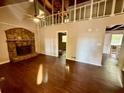 Spacious living room with hardwood floors, stone fireplace, and vaulted ceilings at 5642 Dorsett Shoals Rd, Douglasville, GA 30135