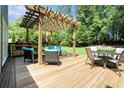 Spacious deck featuring a pergola, ample seating, and an outdoor grill perfect for entertaining at 1655 Peachcrest Dr, Lawrenceville, GA 30043