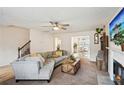 Spacious living room with hardwood floors, a cozy fireplace, and an open floor plan to the dining area at 5686 Grindstone Dr, Buford, GA 30518