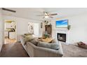 Inviting living room with a cozy fireplace, plush seating, and ample natural light for a comfortable ambiance at 5686 Grindstone Dr, Buford, GA 30518
